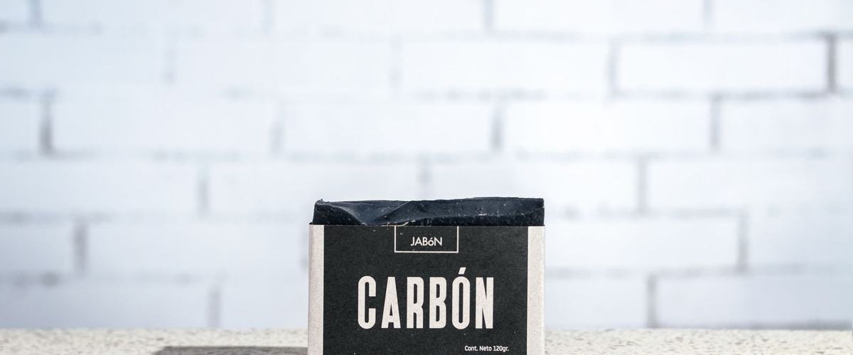 Charcoal bar soap on a textured surface